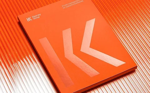 Orange Kearney Group booklet on a ribbed surface